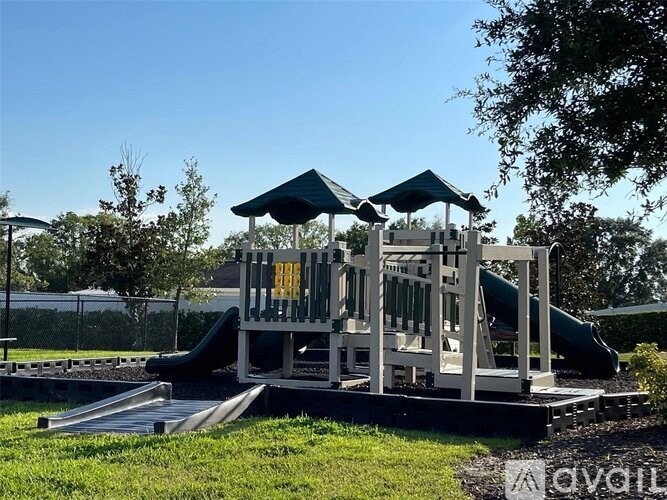 A playground with a slide and a wooden structure.