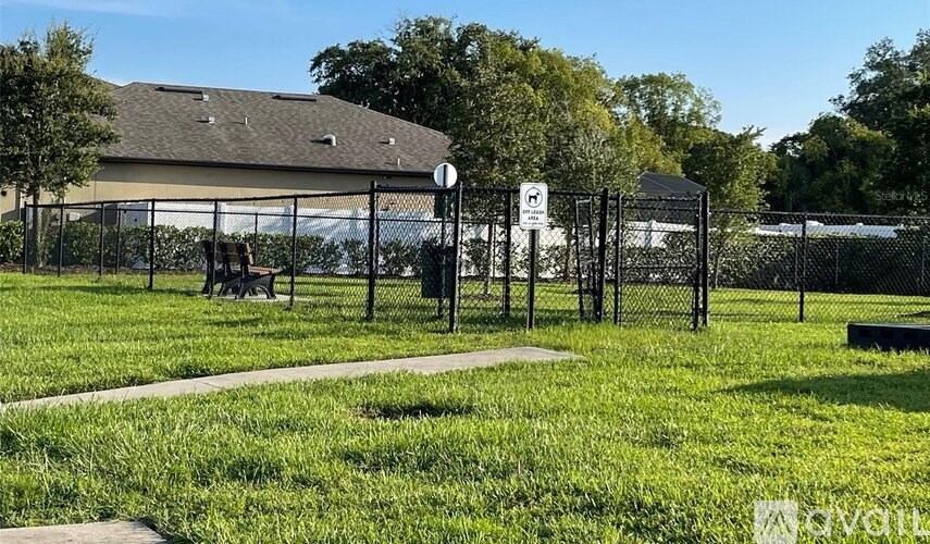 A park with a sign and a bench.