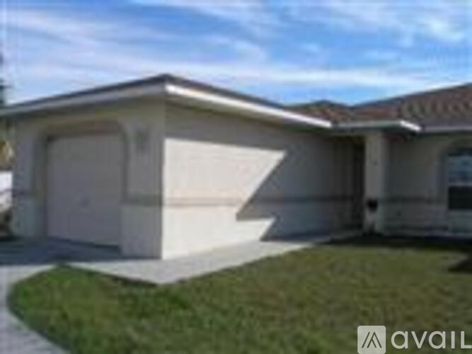 A house with a garage is for sale.