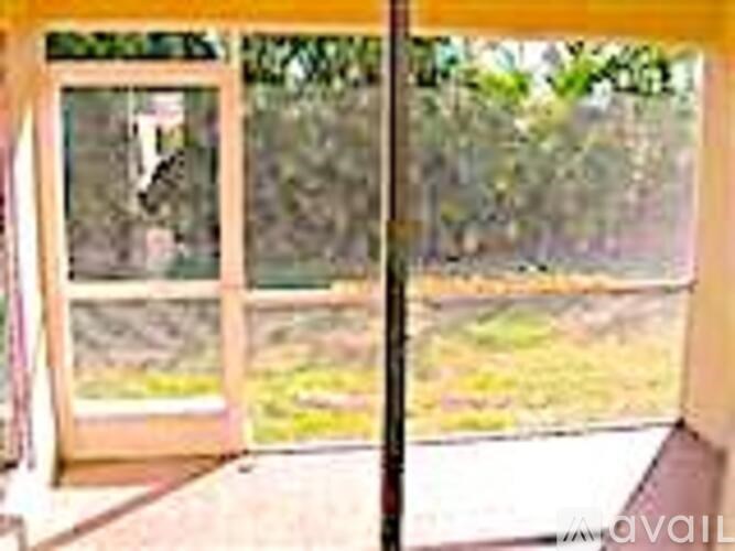 A glass door with a wooden frame is open.