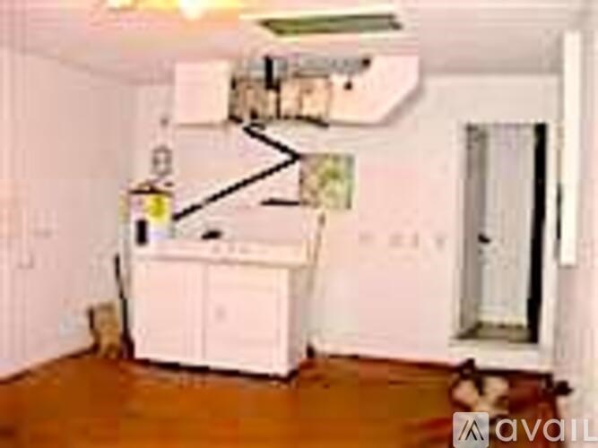 A room with a white cabinet and a white door.