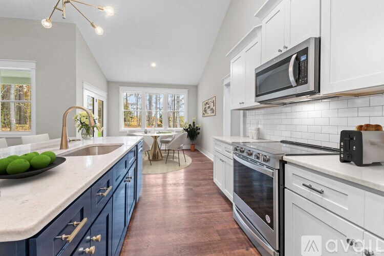 A kitchen with a white countertop and blue cabinets.