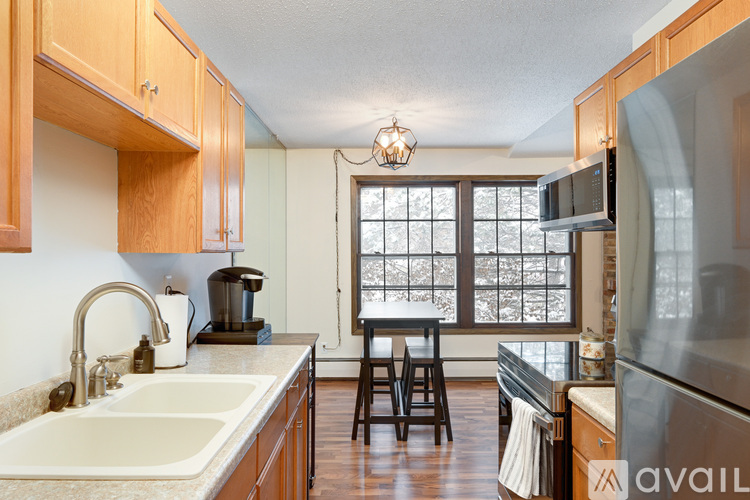 A kitchen with wooden cabinets and a sink.