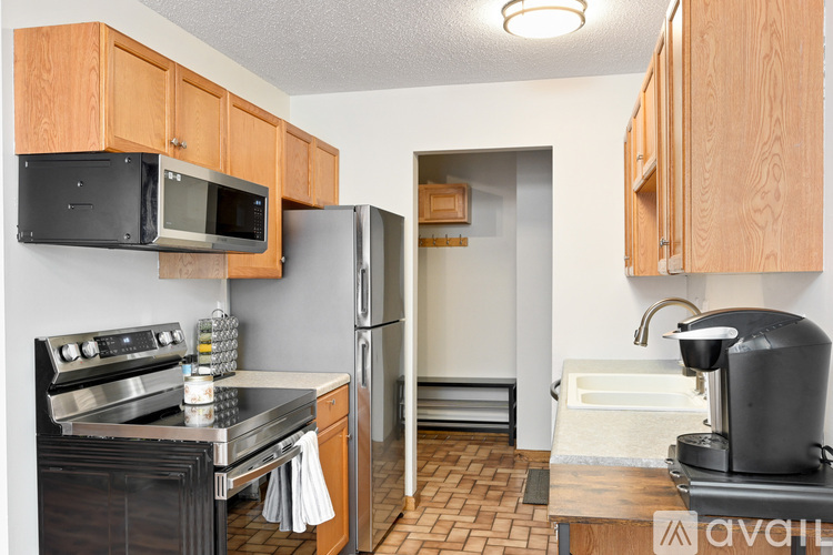 A kitchen with wooden cabinets and a black stove top oven.
