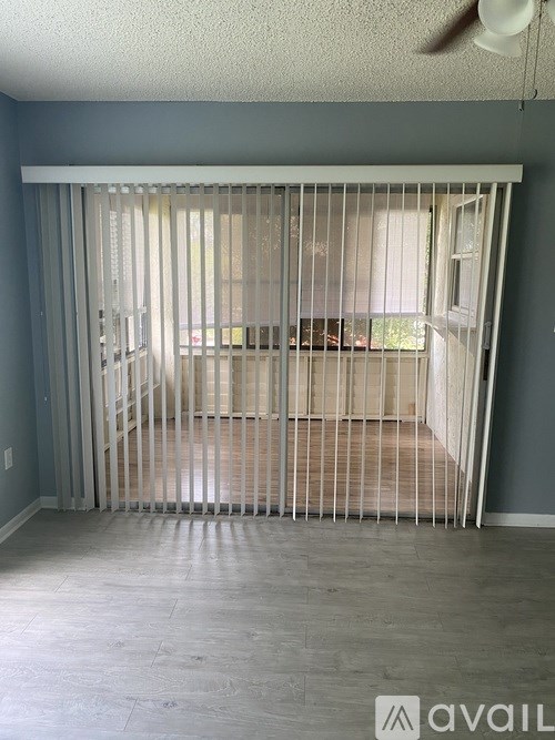 A room with a sliding door and a fan on the ceiling.