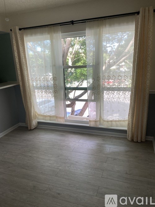 A room with a sliding glass door leading to a balcony.
