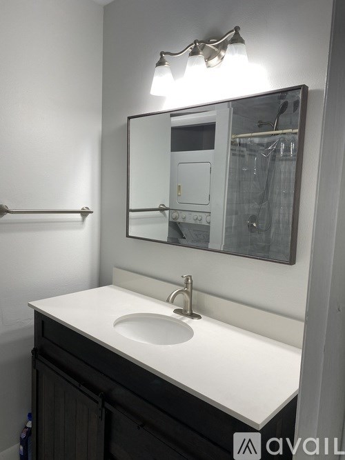 A bathroom with a sink and mirror.