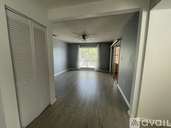A modern house with a curved staircase and a white fence.