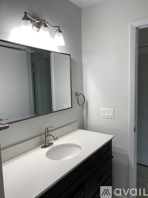 A bathroom sink with a mirror above it.