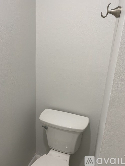 A white toilet in a small bathroom.