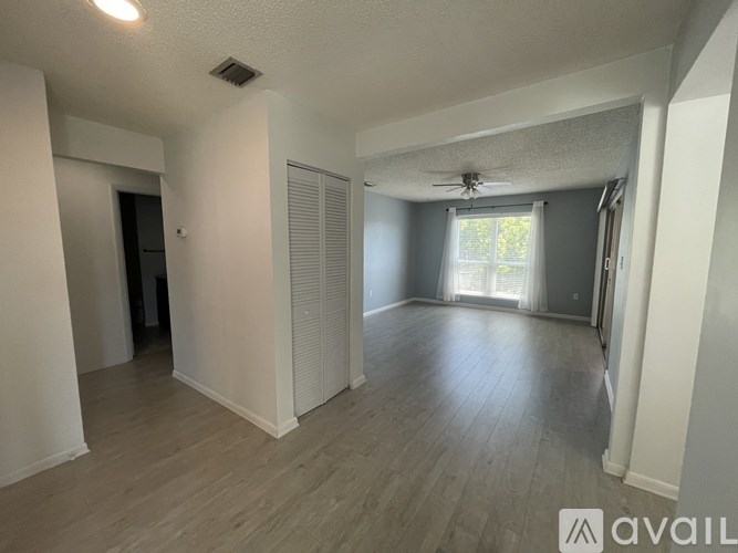 A hallway with a red door and a white door.