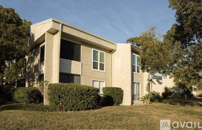 A modern house with a well-maintained lawn in front.