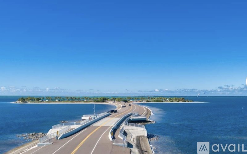 A bridge over a body of water with a clear blue sky.