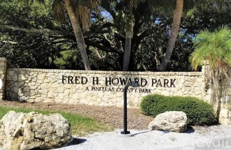 A stone wall with a sign that says Fred H. Howard Park.
