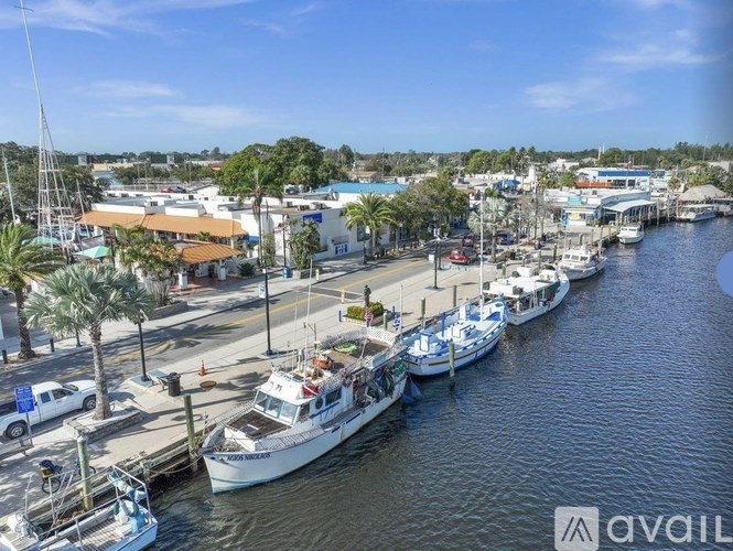 A marina with boats docked and a clear blue sky.