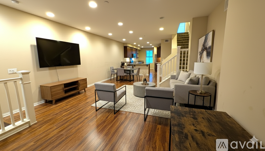 A bedroom with a large bed and a flat screen TV on a wooden stand.