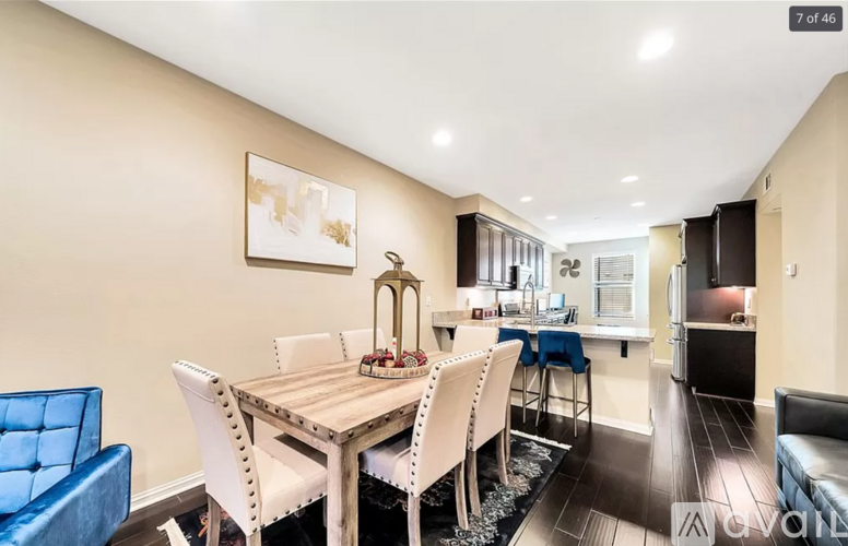 A dining room with a wooden table and chairs.