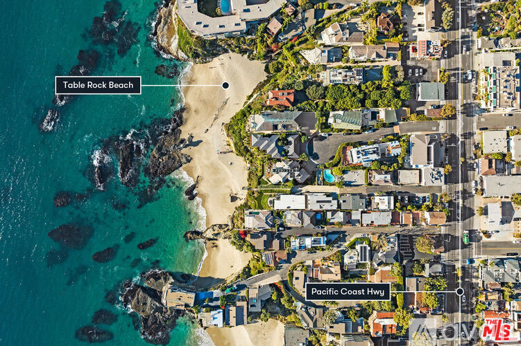 An aerial view of a beach and a residential area.