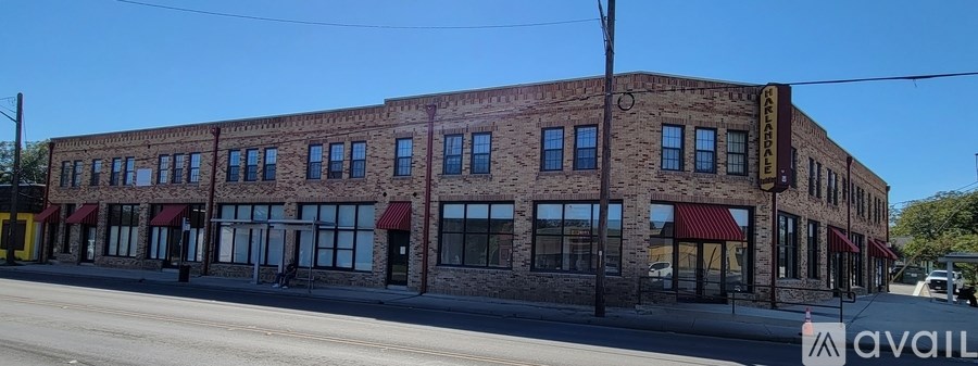 A large brick building with a red awning is available for rent.