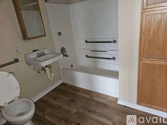 A bathroom with a toilet, sink, and bathtub.