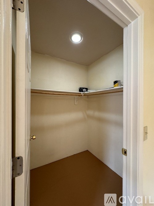 A small, empty room with a single light fixture on the ceiling.