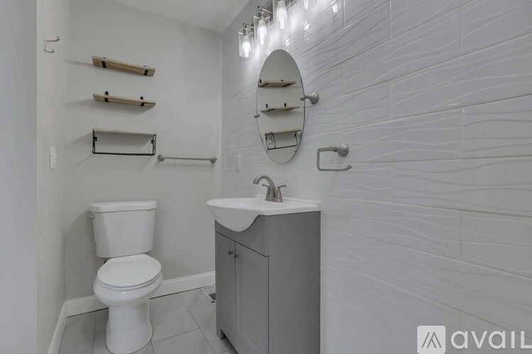 A white toilet sits next to a sink in a bathroom.