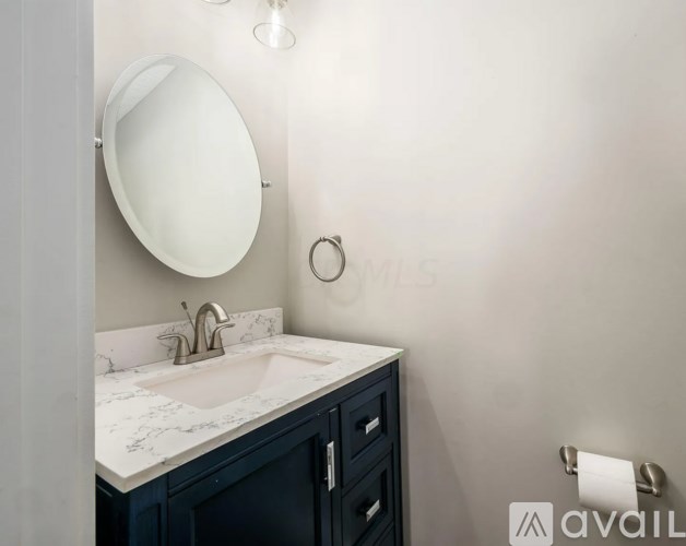 A bathroom with a sink and a mirror.