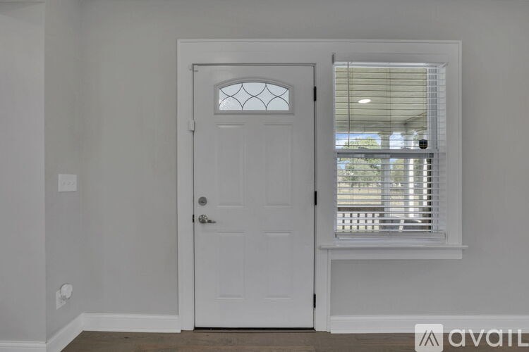 A room with a white door and windows.