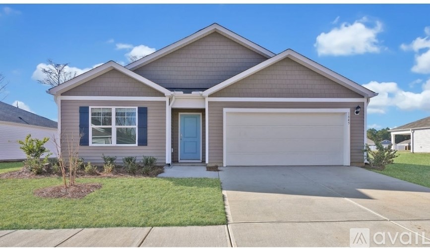 A house with a blue door and a garage door is for sale.