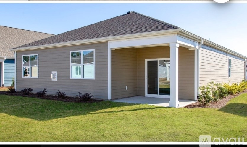 A house with a grey and beige exterior and a white door.