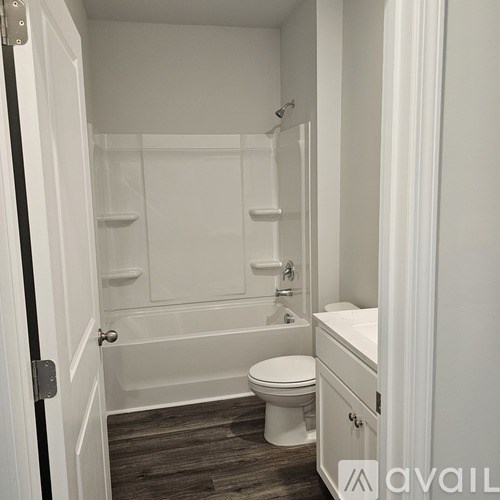 A small white bathroom with a toilet, sink, and bathtub.