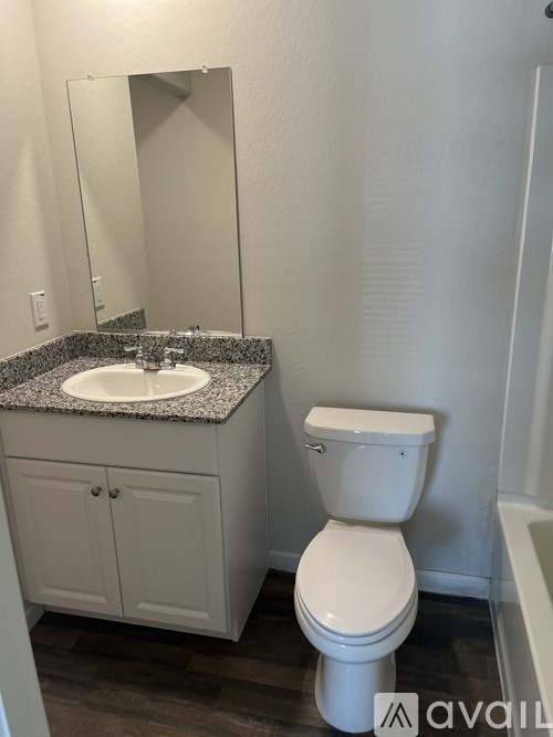 A white toilet sits next to a sink in a bathroom.