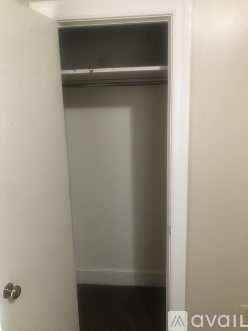 A white door with a handle and a small window above the door.