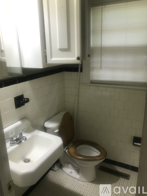 A white toilet sits next to a sink in a small bathroom.