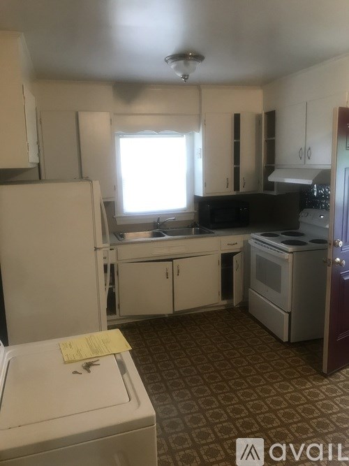 A kitchen with a washer and dryer in it.