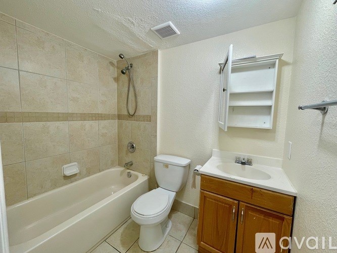 A bathroom with a toilet, sink, and bathtub.
