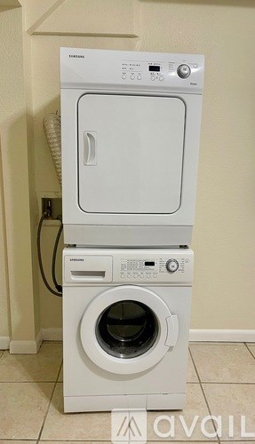 A white dryer and washer stacked on top of each other.