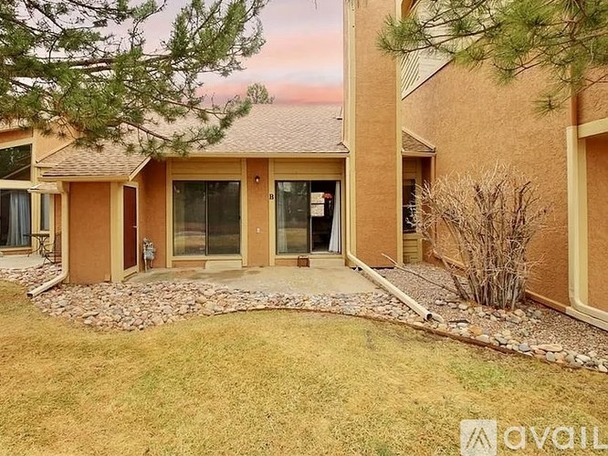 A house with a brown exterior and a stone pathway leading to the front door.