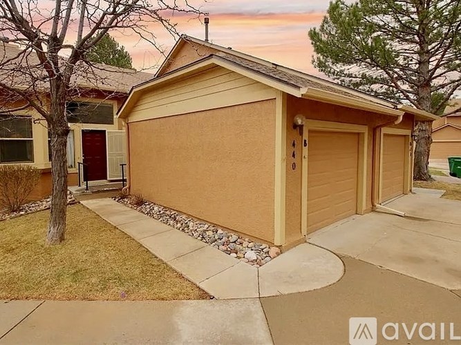 A two-car garage with a brown siding and a red door is available for rent.