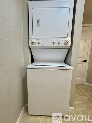 A white oven with a door and knobs on the front.