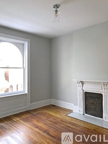 A room with a fireplace and a window.