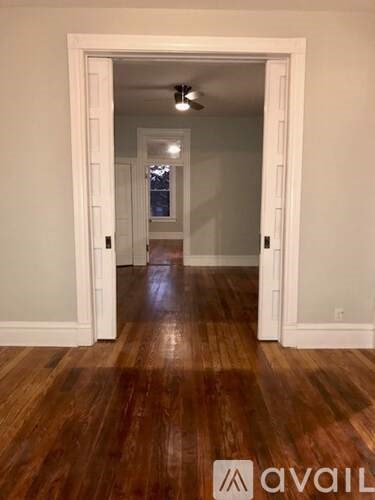 A room with wooden floors and white walls.