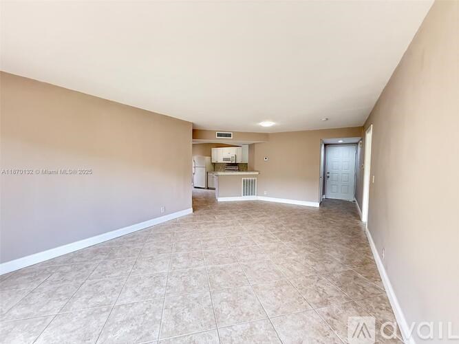 Empty room with beige walls and tiled floor.