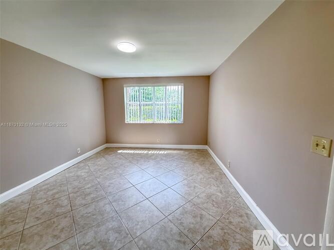 Empty room with tiled floor and a window.