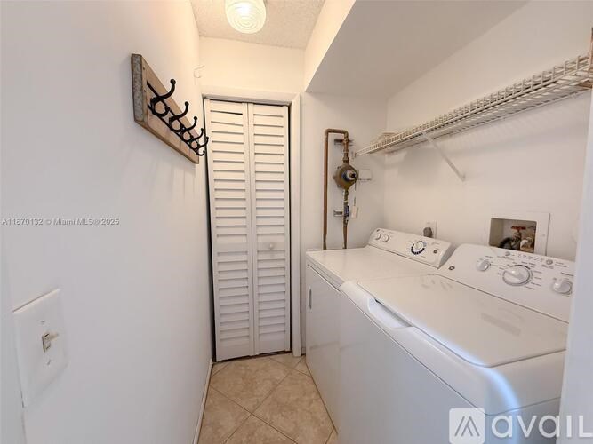 A small laundry room with a washer and dryer.