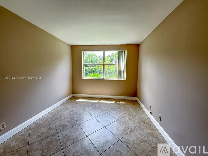 Empty room with tiled floor and a window.