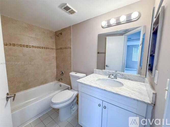 A bathroom with a toilet, sink, and bathtub.