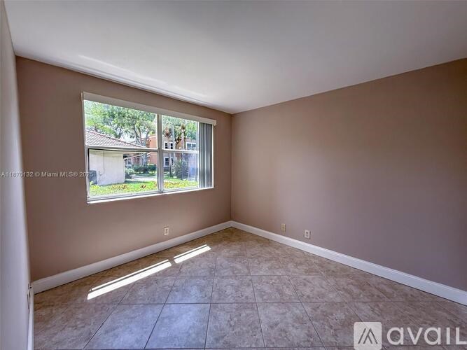 A room with a large window and tiled floor.