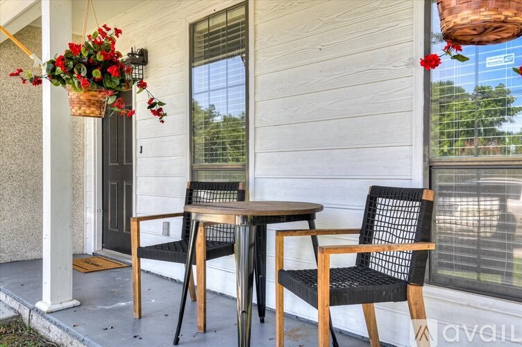 A patio with a table and two chairs.