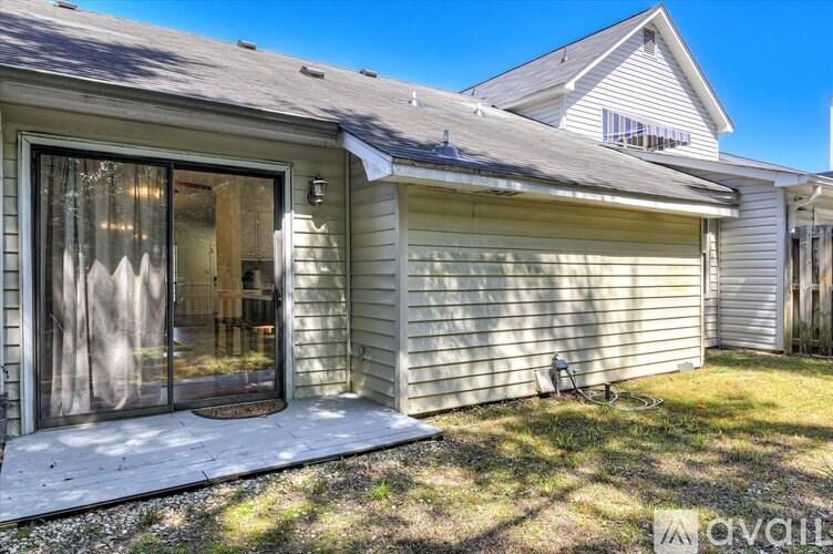 A house with a garage and a bicycle parked outside.